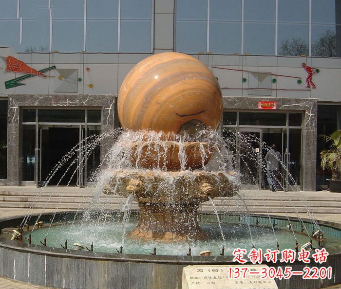 达州石来运转球晚霞红风水球石雕